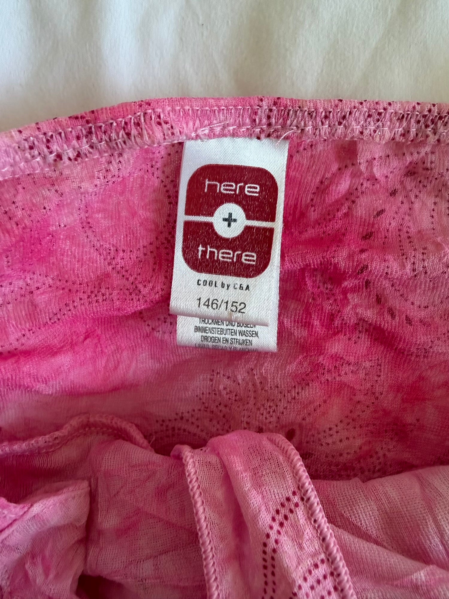 Vintage pink knot bust cami with floral print and sparkly detail and lettuce hem