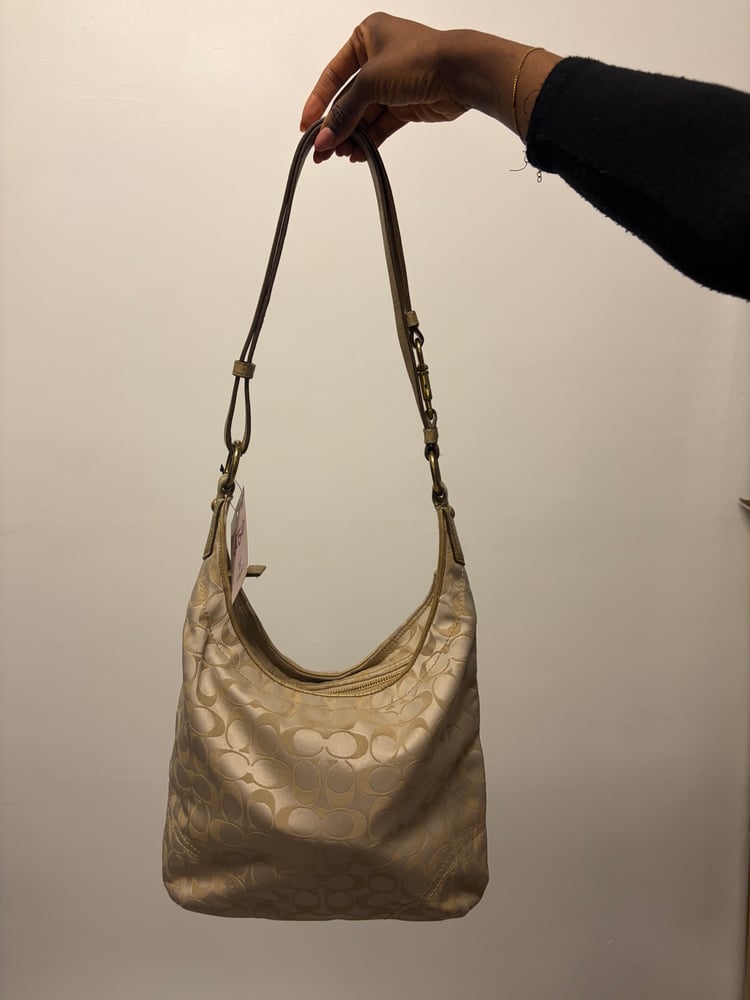 2012 Coach monogram hobo shoulder bag with a beige and gold floral appliqué design