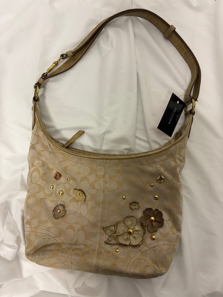 2012 Coach monogram hobo shoulder bag with a beige and gold floral appliqué design