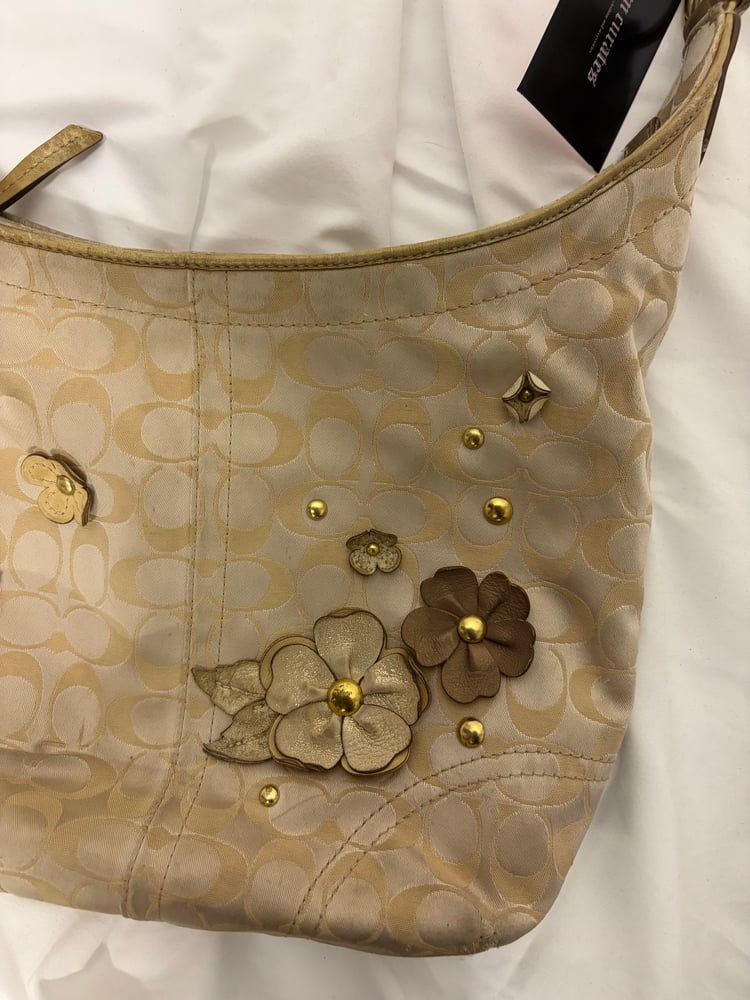 2012 Coach monogram hobo shoulder bag with a beige and gold floral appliqué design