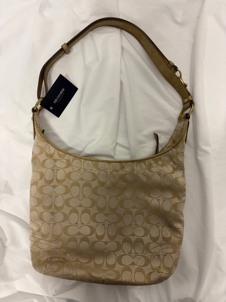 2012 Coach monogram hobo shoulder bag with a beige and gold floral appliqué design