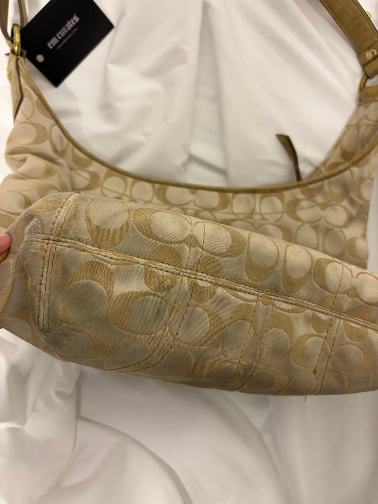 2012 Coach monogram hobo shoulder bag with a beige and gold floral appliqué design