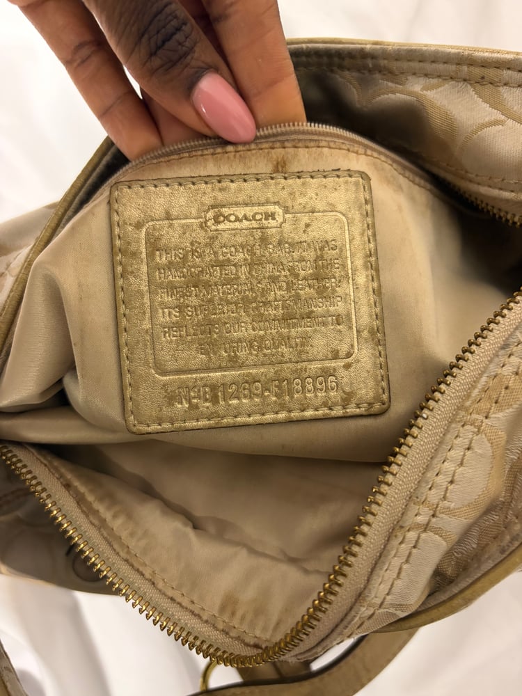 2012 Coach monogram hobo shoulder bag with a beige and gold floral appliqué design