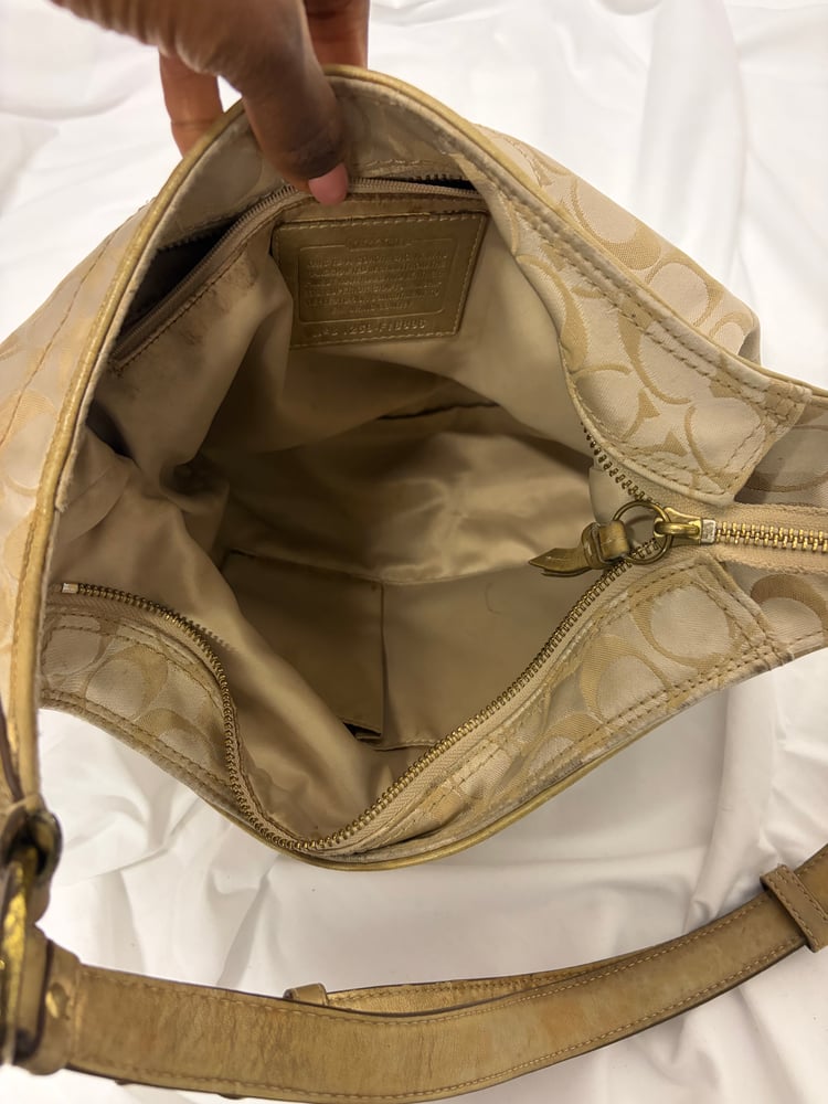 2012 Coach monogram hobo shoulder bag with a beige and gold floral appliqué design